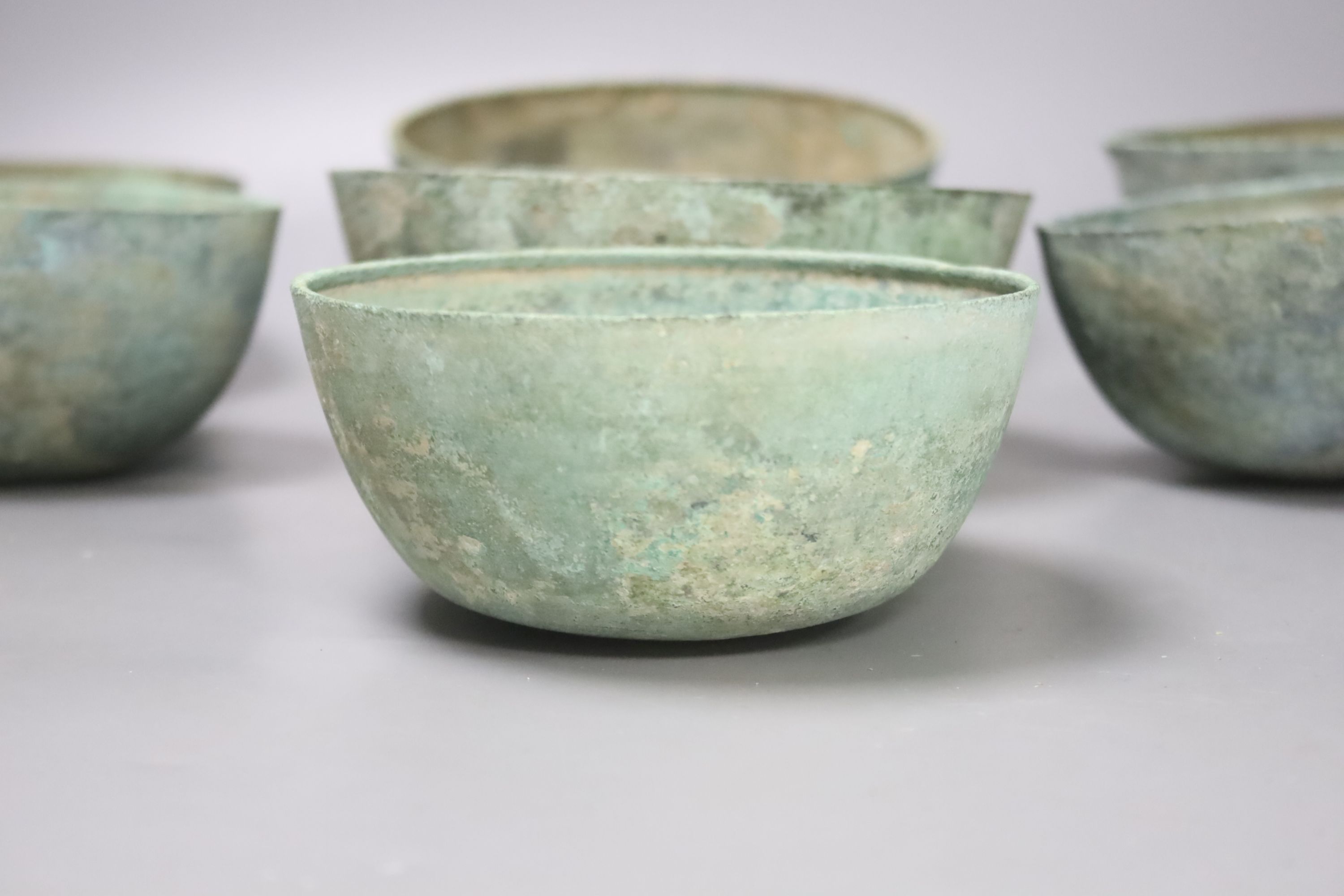 Seven Cambodian bronze ritual offering or water bowls, Khmer, 12th/13th century